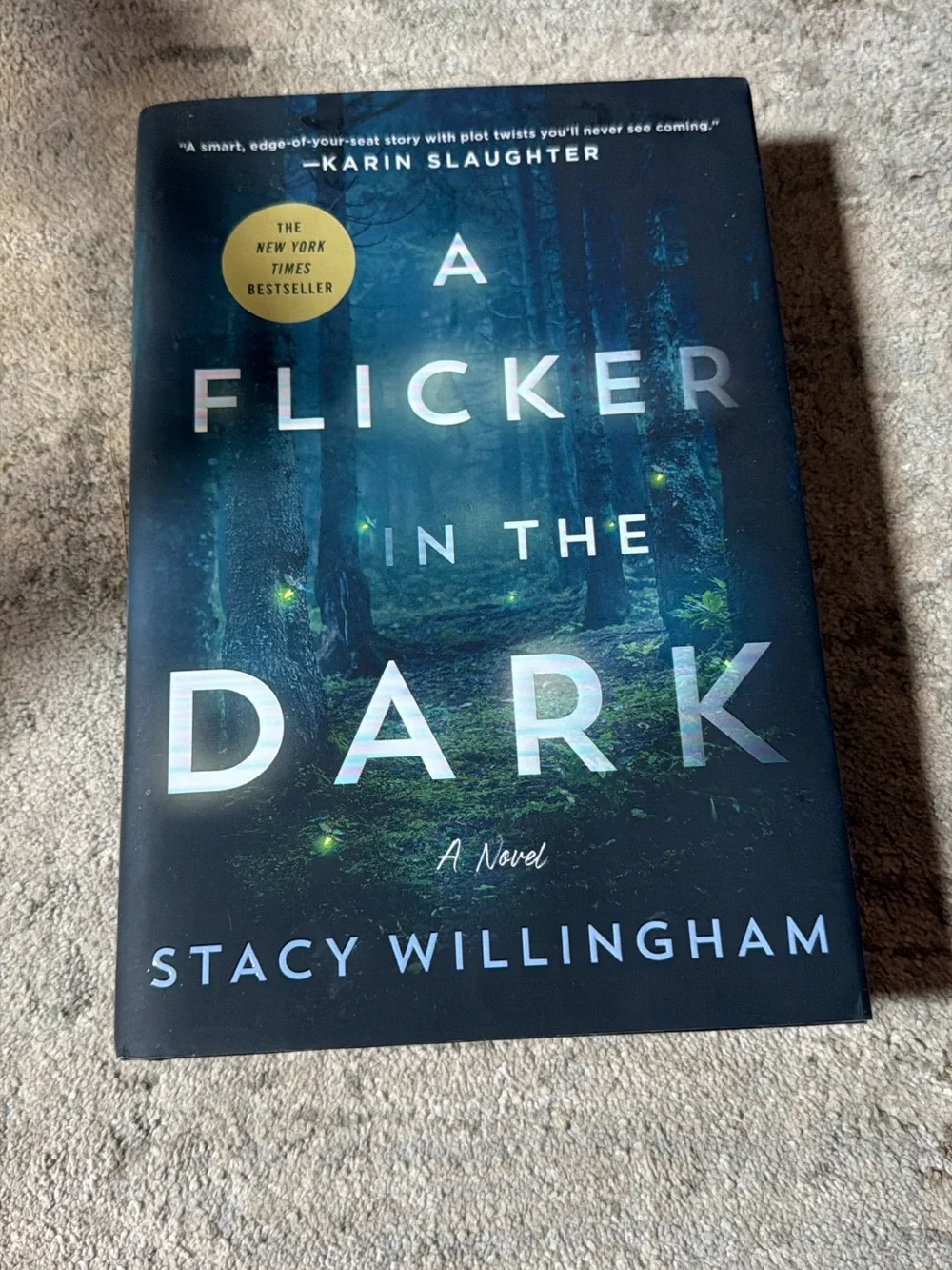 A Flicker in the Dark by Stacy Willingham - Dark Blue Hardcover Novel